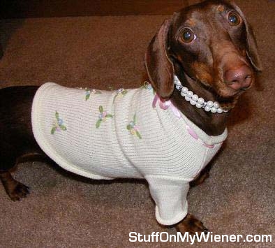 Anya with a sweater and pearl necklace.