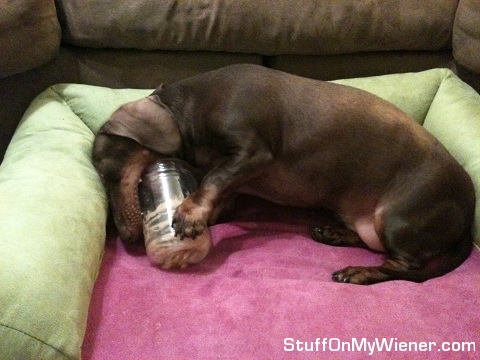 Anya with her face in peanut butter jar.